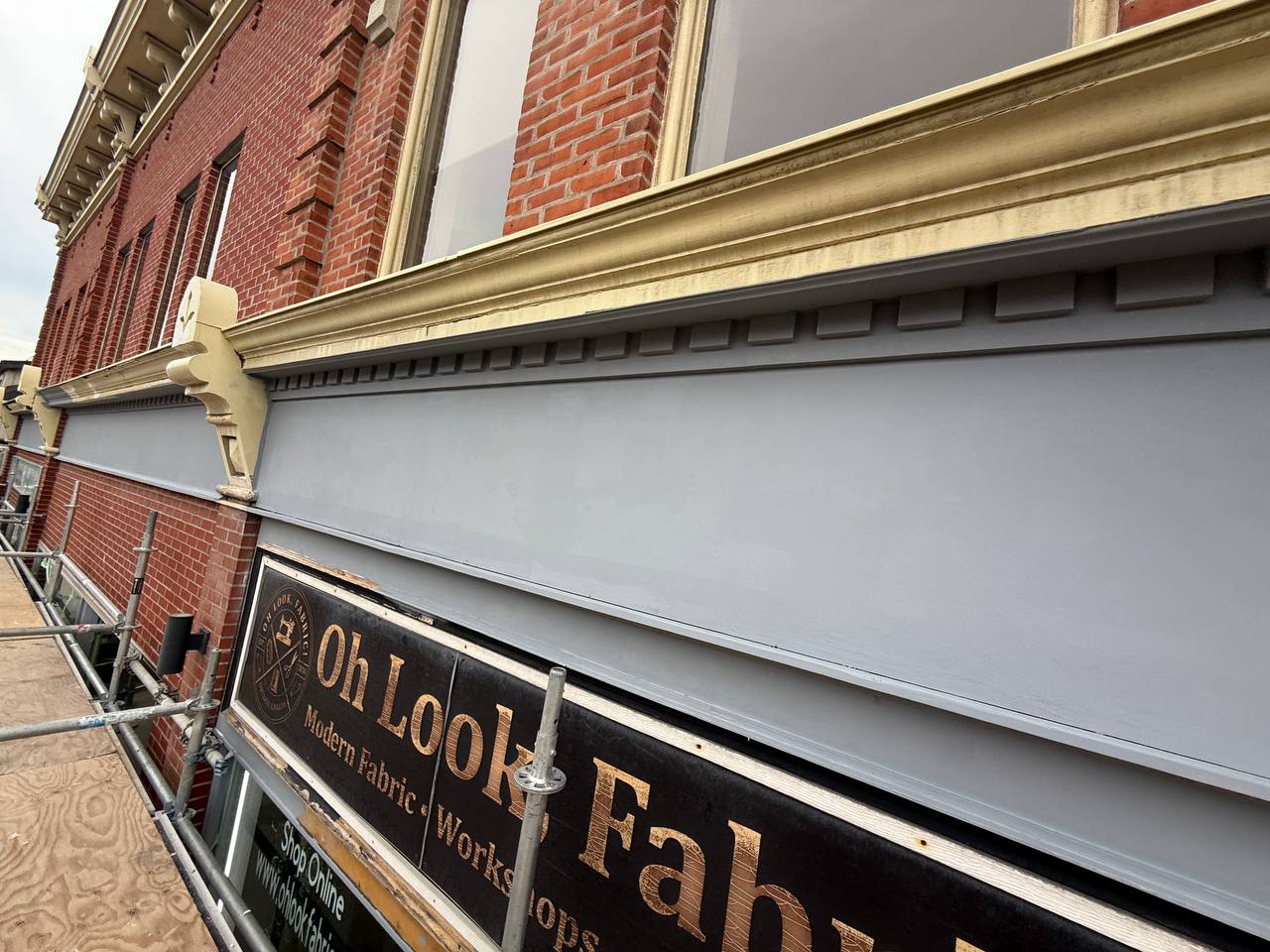 Commercial facade restoration with scaffolding and cladding