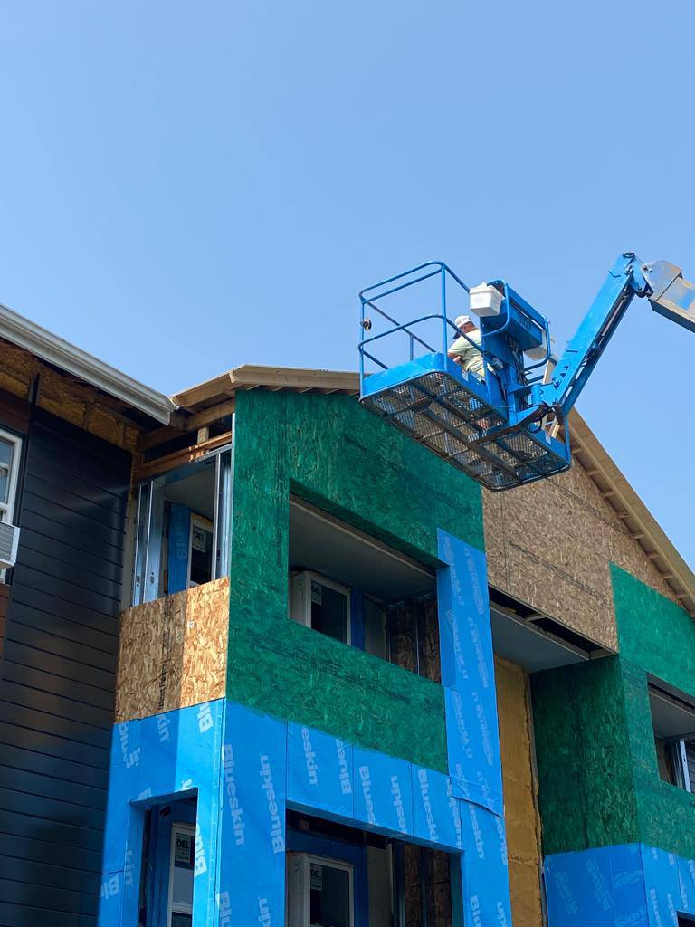 Exterior restoration and siding work from an aerial lift